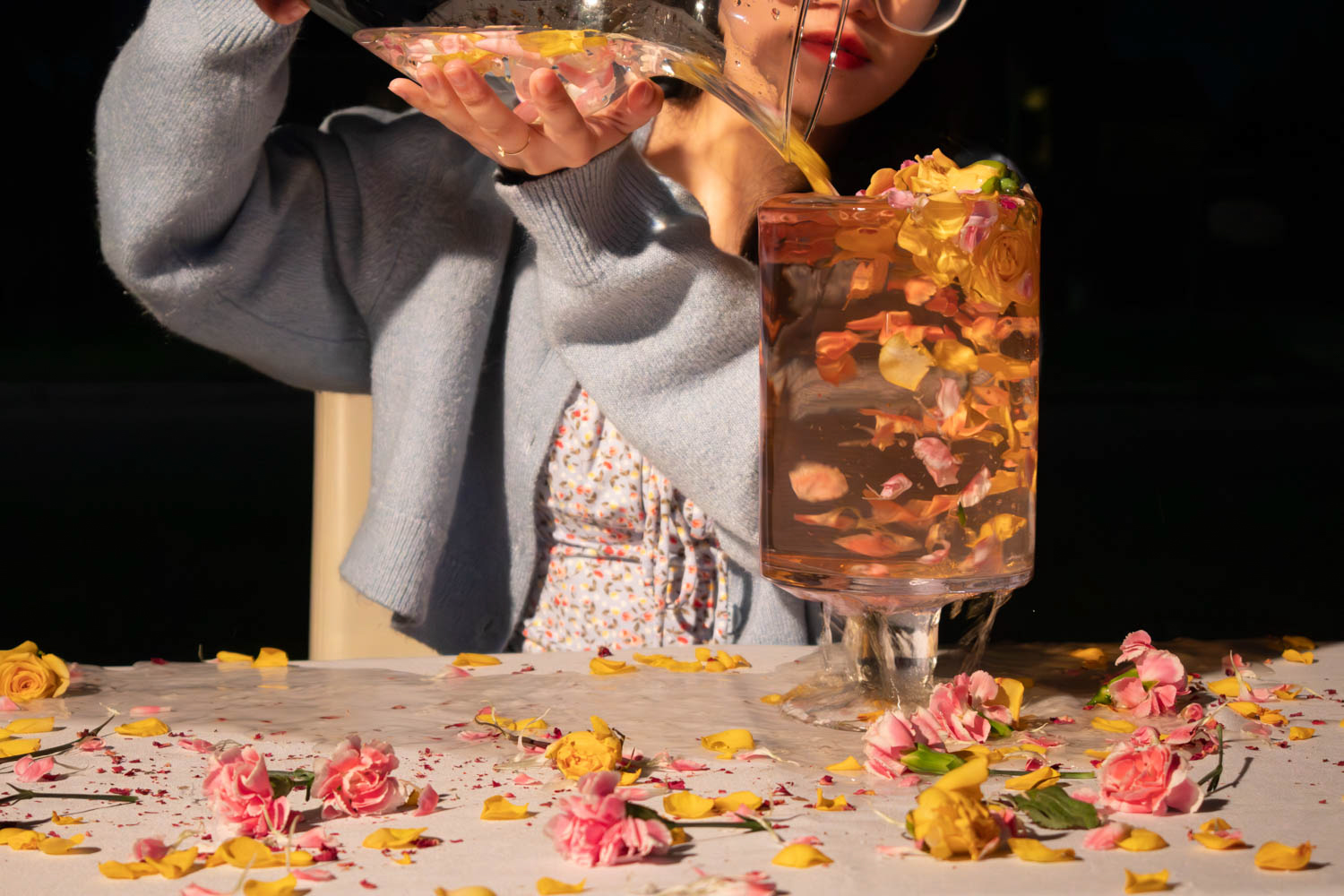 Flowers and petals swirling in a glass container